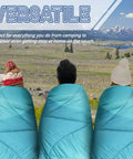 Three people in green Outdoor Puffy Camping Blanket With Lightweight Down Alternative Fill enjoying a scenic landscape.