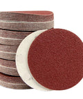 25 Piece Hook And Loop Sanding Discs Assortment Featuring 40 To 3000 Grit Sizes stacked assortment for metal polishing and wood buffing.