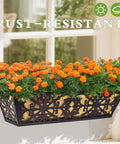 Black 24 inch window box planter with rust-resistant frame and coco liner, filled with orange flowers, mounted on window.