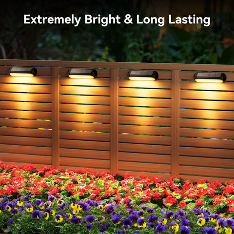 4 Pack Solar Outdoor Lights with RGB Color Changing and Warm White Modes on Fence Overlooking Bright Flowers