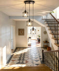 Slick Farmhouse Three Light Pendant With Adjustable Drop Cords Matte Black Hanging Ceiling Lamp in entryway with patterned floor.