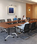 Flip Top Mobile Desk With Lockable Casters And Portable Folding Workstation For Home Office Or Classroom Use in a meeting room setting.