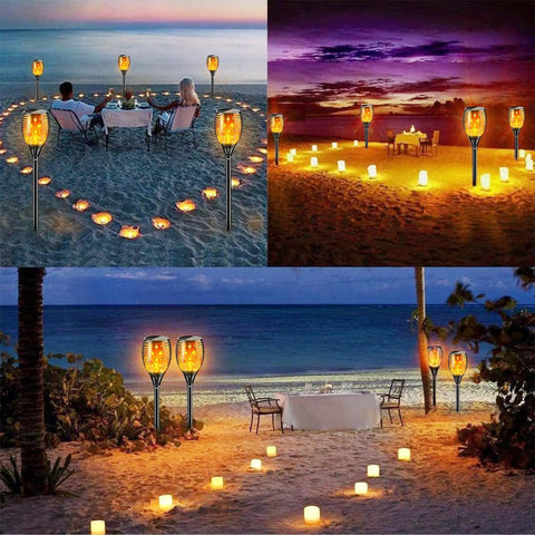Solar Torch Lights With Flickering Flame For Outdoor Garden Yard And Patio 43 Inch Tall Waterproof Landscape Path Lighting Realistic Flame Effect Adjustable Height 4 Pack on beach setting
