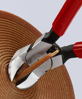 Pro Grade 85 Degree Diagonal Flush Cutters with Angled Blades cutting sprue from soft material, red and silver tool