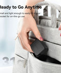 Person placing Dope Mini LED Vlogging Light For Action Cameras With 12 LEDs in gray backpack pocket.