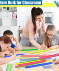 32 Pack 12 Inch Plastic Rulers Set With Transparent Colorful Dual Sided Measuring Tool Featuring Inches Centimeters And Millimeters For Kids Back To School Office And Home Supplies display on classroom table
