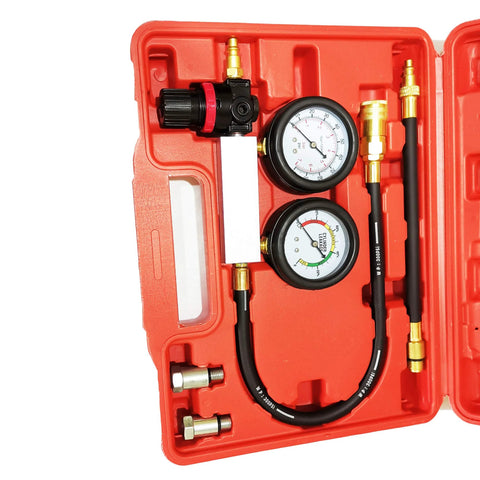 Front view of engine leak-down tester kit with dual gauges, hoses, brass fittings in red plastic case.