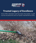 Garden rake clearing debris from under bushes next to a lawn, showcasing tools for turf grass maintenance by Standard Golf.