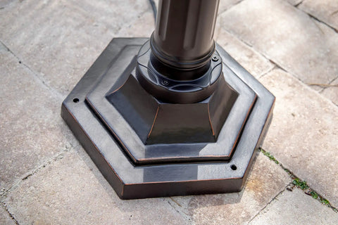 Base of Villa Waterproof Outdoor Lamp Post Light in Oil Rubbed Bronze with vintage lantern style on stone pathway.