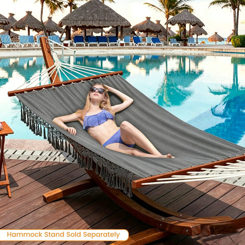 Woman relaxing on Cotton Double Hammock With 55 Inch Spreader Bar by a pool, Dark Gray