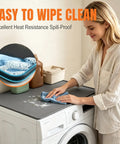 Woman cleaning Top Shelf Silicone Washer And Dryer Top Mat 26 By 18 Inch Waterproof Countertop Protector Non Slip.