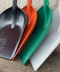 Four colorful poly snow scoop shovels, including black, with 42 inch handles, ready for quick winter cleanup of walkways and decks.
