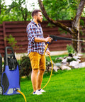 Man using pressure washer with Six Pack Three Quarters Inch Pressure Washer Garden Hose Adapter on lawn