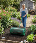 Gardener using Heavy Duty 30 Inch Compost And Peat Moss Spreader With Push Or Tow Handle Adjustable Height Powder Coated Steel Basket 3.4 Cu Ft Capacity For Spreading Manure Mulch Topsoil Seed Fertilizer in garden.