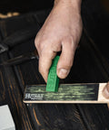 Hand using Pocket Knife Strop Kit On The Go Sharpening With Leather Strop And Stropping Compound for razor sharp edges
