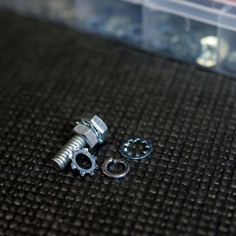 Large Cotter Pin Key 144 Pc Assortment Set 1 Eighth By 2 In To 1 Quarter By 3 In Steel Heavy Duty Locking Automotive Axle Trailer Pins For Mechanic Jobs And Small Engine Repairs. Close-up of metal fasteners on textured surface with storage case in background.