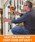 Man using Powerful 1800W Heat Gun With Dual Temps 752F And 1112F on stair railing, showcasing paint stripping with ease.