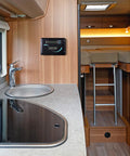 Interior view of a camper van kitchen with sink, stove, and PWM controller, designed for efficient trail camping use.