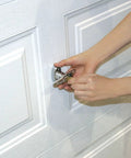 Universal Garage Door Lock Kit With Spring Latch And Keyed Handle being installed on overhead garage door panel