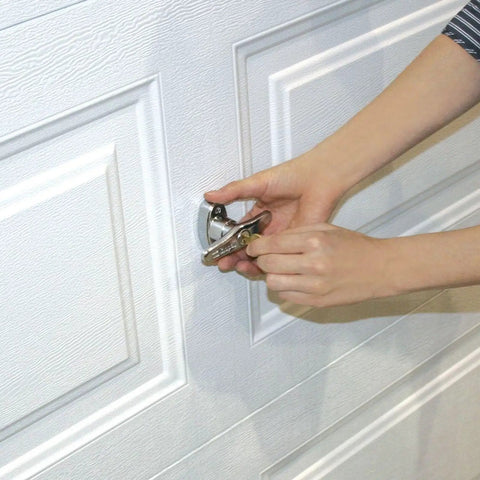 Universal Garage Door Lock Kit With Spring Latch And Keyed Handle being installed on overhead garage door panel