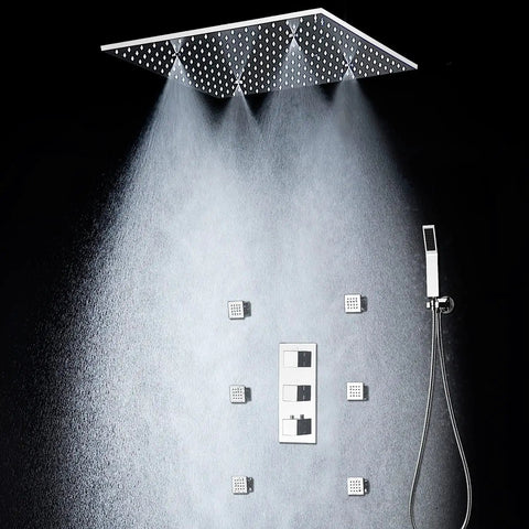 Heavy Duty 20X40 Inch Shower Panel System With Solid Three Knob Thermostatic Mixer And Four Mode Settings Like Rainfall Mist Massage Jets Plus Independent Hand Shower In Classic Antique Brass showing overhead rain head and body sprays.