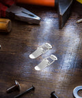 Nickel Plated Iron Spring Duckbill Latch Set Four Pack For Toolboxes And Equipment Cases Cabinet Drawer Locks Quick Secure Locking Hardware For Doors And Storage Projects on a workbench with tools.