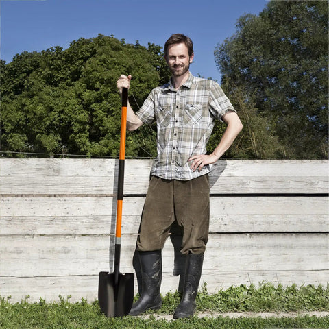 Man holding Heavy Duty Garden Shovel With 56 Inch Round Blade And Fiberglass Handle In Orange For Tough Digging And Yard Work Pro Grade Non Slip Grips For Comfort And Control