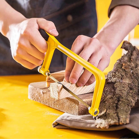 Person using 6 Inch Mini Hacksaw And Miter Block Set With Bi-Metal Blade Extra Fine Cut For Wood Plastic Glass Metal DIY Home Renovation And Craft Projects A Handy Portable Hand Saw Kit to cut wood