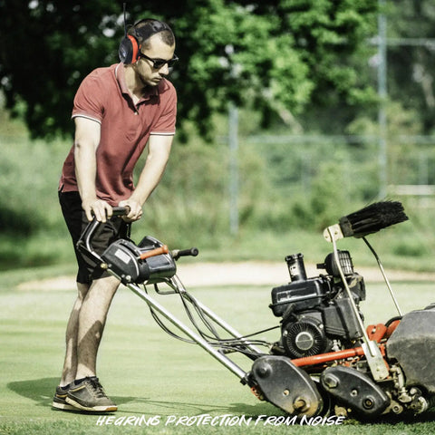Man mowing lawn while wearing Safety Bluetooth Earmuffs For Mowing And Power Tools With FM Radio NRR 29dB Industrial Hearing Protection.