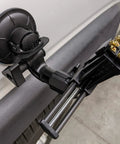 Kickass Vacuum Bench Vise For Smooth Workbenches With No Sweat Clamping Mechanism Featuring Low Key Tilt Rotate Knobs Beefy Grooved Jaws Perfect For Delicate Hobby Crafts And Circuit Repair Black attached to a flat surface with visible clamps.
