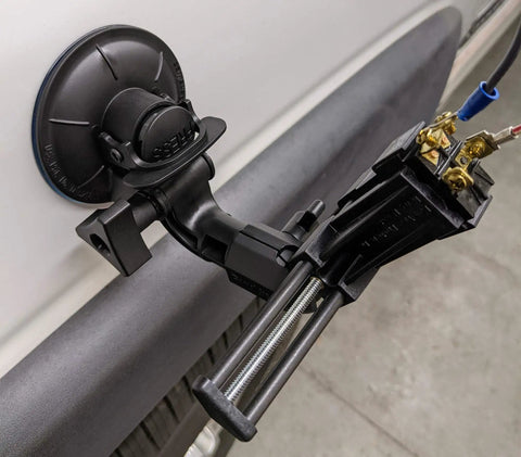 Kickass Vacuum Bench Vise For Smooth Workbenches With No Sweat Clamping Mechanism Featuring Low Key Tilt Rotate Knobs Beefy Grooved Jaws Perfect For Delicate Hobby Crafts And Circuit Repair Black attached to a flat surface with visible clamps.