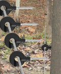 Dang Solid Heavy Duty Screw In Electric Fence Insulators 30 Pack With Timber Post Brackets and Included Steel Drill Socket For Ranch Livestock Boundary Grid Wiring installed on wooden posts with wire.