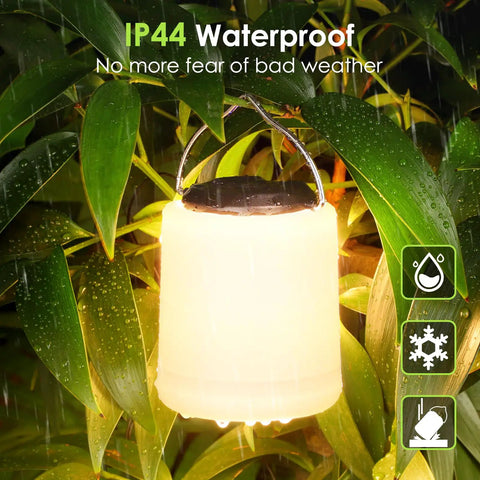 IP44 water-resistant Powerful 1000LM LED Camping Lantern With Rechargeable Battery hanging amid rainy foliage