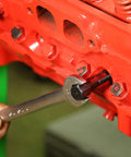Mechanic using Cylinder Head Rethread Kit For Aluminum Heads Only With Tap And Reamer to repair spark plug thread on engine