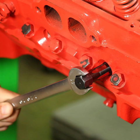 Mechanic using Cylinder Head Rethread Kit For Aluminum Heads Only With Tap And Reamer to repair spark plug thread on engine