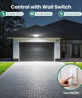 70W 7000LM LED Flood Light With 4 Adjustable Heads illuminating garage exterior at night, wall switch highlighted