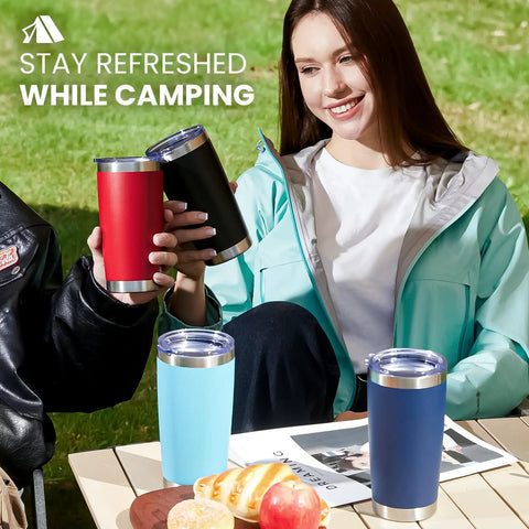 Eight Tough As Nails Twenty Ounce Double Wall Insulated Stainless Steel Tumblers With Secure Lids And Straws That Keep Your Sippin Frosty Or Steaming Hot All Day Long In Sleek Black Finish, shown in use while camping.