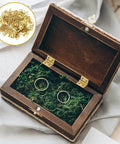 Gold Mini Hinges Set 30 Piece Tiny 13x12mm Brass Butt Hinges With 180 Degree Rotation For Wooden Boxes Jewelry Boxes Dollhouses And DIY Projects Includes Screws For Tiny Builds shown installed on a wooden box with rings inside.