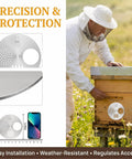 Two Pack Galvanized Iron Bee Hive Entrance Discs For Beekeeping Nuc Box Entrance Reducers 4.92 Inch Diameter Durable Beekeeping Gear And Beekeeping Supplies For Beekeepers shown on a hive with beekeeper