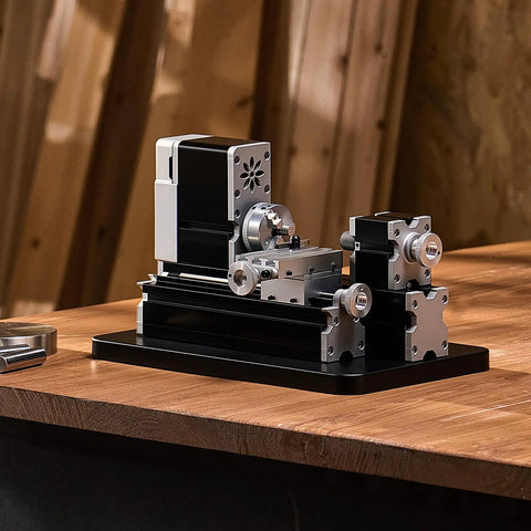 Compact didactical mini metal lathe on a workbench, 20,000 RPM, 36W, with 3 jaw chuck and aluminum handwheel for DIY soft metals and plastics.