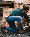 Person wearing mens steel toe waterproof work boots slip on safety shoes while lifting wooden planks