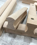Close-up of Six Unfinished Beech Wood Furniture Pull Handles Set For Cabinets And Drawers, Unpainted Paintable Wooden Pulls, 5.12 Inch Length