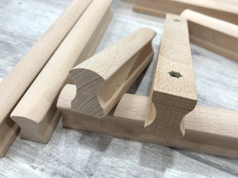 Close-up of Six Unfinished Beech Wood Furniture Pull Handles Set For Cabinets And Drawers, Unpainted Paintable Wooden Pulls, 5.12 Inch Length