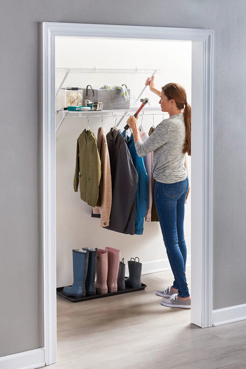 Woman organizing clothes on Three Foot Wide Wire Wall Shelf System With Mounting Hardware White Space Saving Organizer