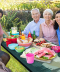Family enjoying outdoor meal on Picnic Table Cover Set With Bench Covers, Windproof And Waterproof 72 Inch Tablecloths, green blue design.