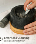 Heavy Duty Granite Mortar And Pestle Set 2 Cup Stone Grinder For Spices And Herbs With Non Slip Wooden Base being cleaned