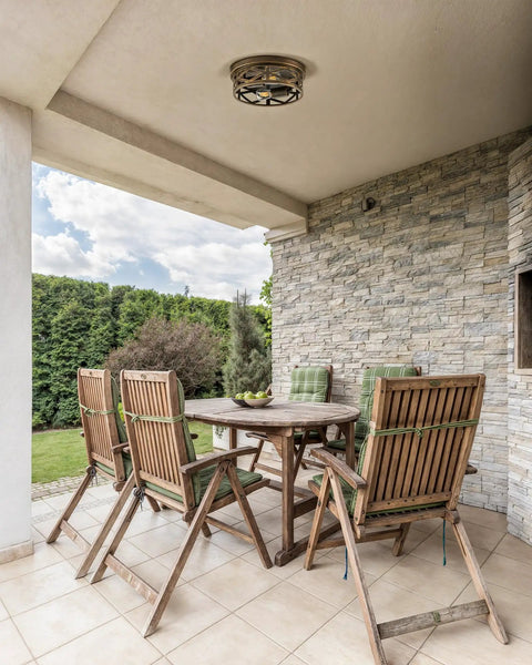 Outdoor patio with wooden furniture showcasing Industrial Three Bulb Ceiling Light With Vintage Metal Cage, Oil Rubbed Bronze Flush Mount Fixture.