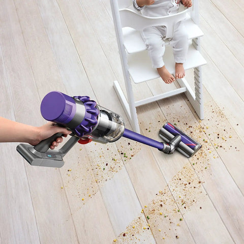 Cyclone V10 Animal Cordless Vacuum Cleaner with Quick Release Extension Hose cleaning under high chair on hardwood floor