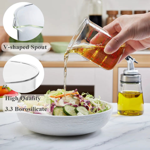 Borosilicate Glass Measuring Cup 1 Cup 8oz with Spout pouring liquid into salad, showing V-shaped spout and clear readouts.