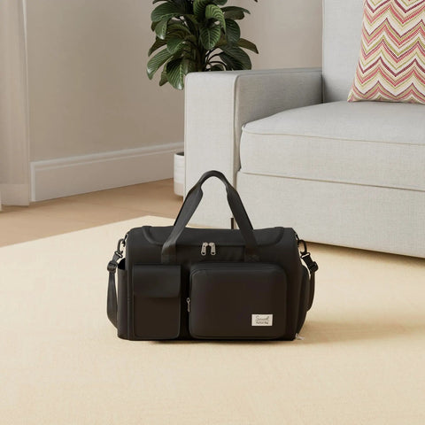 Black Sports Duffel Bag With Shoe Compartment And Wet Dry Separated Pocket on beige carpet next to sofa